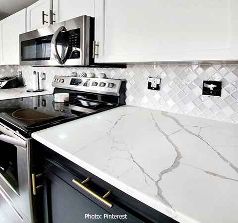 Elegant subway tile backsplash in a contemporary kitchen by ASASA Kitchens.